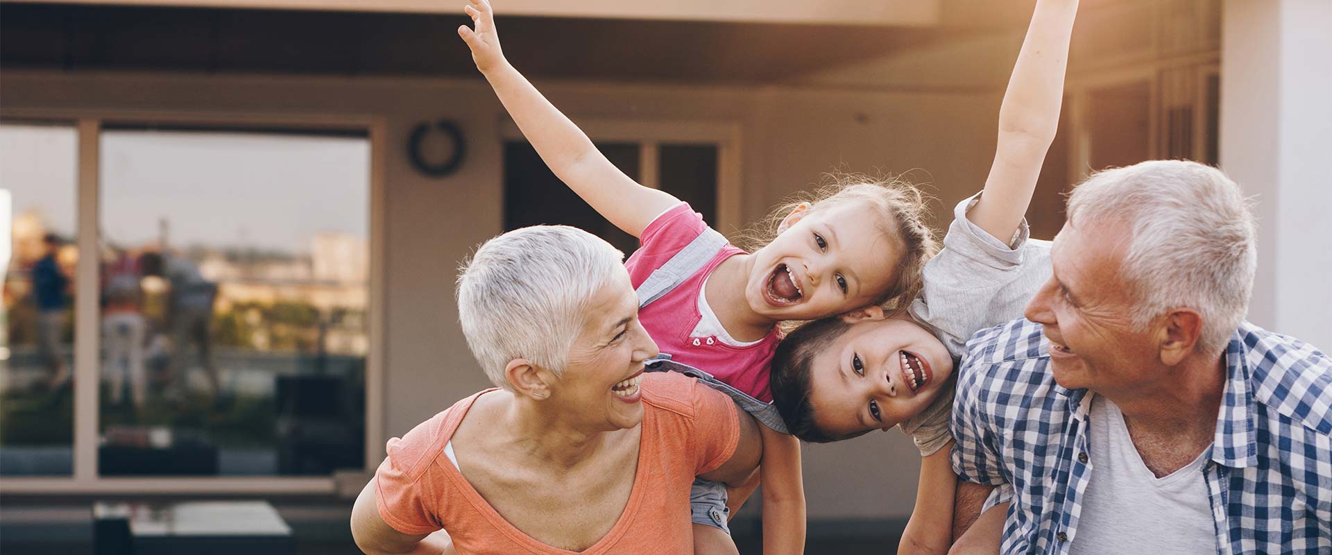 grandparents playing outside with their grandchildren